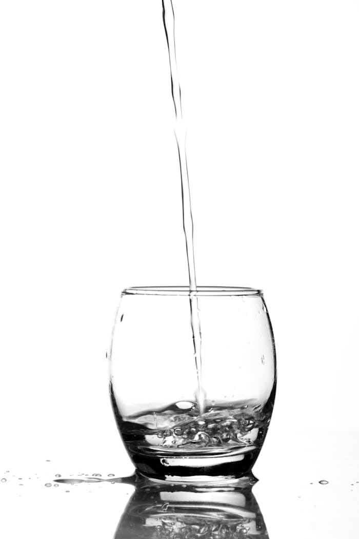 about-02 Refreshing image of water being poured into a glass, emphasizing purity and clarity.