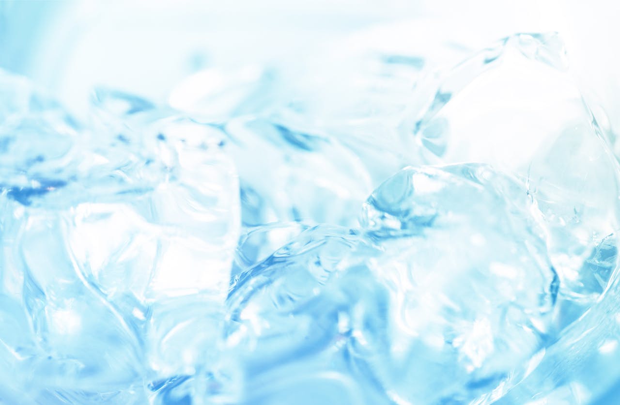 services-03 Abstract close-up of ice cubes against a bright blue background, capturing the essence of freshness.
