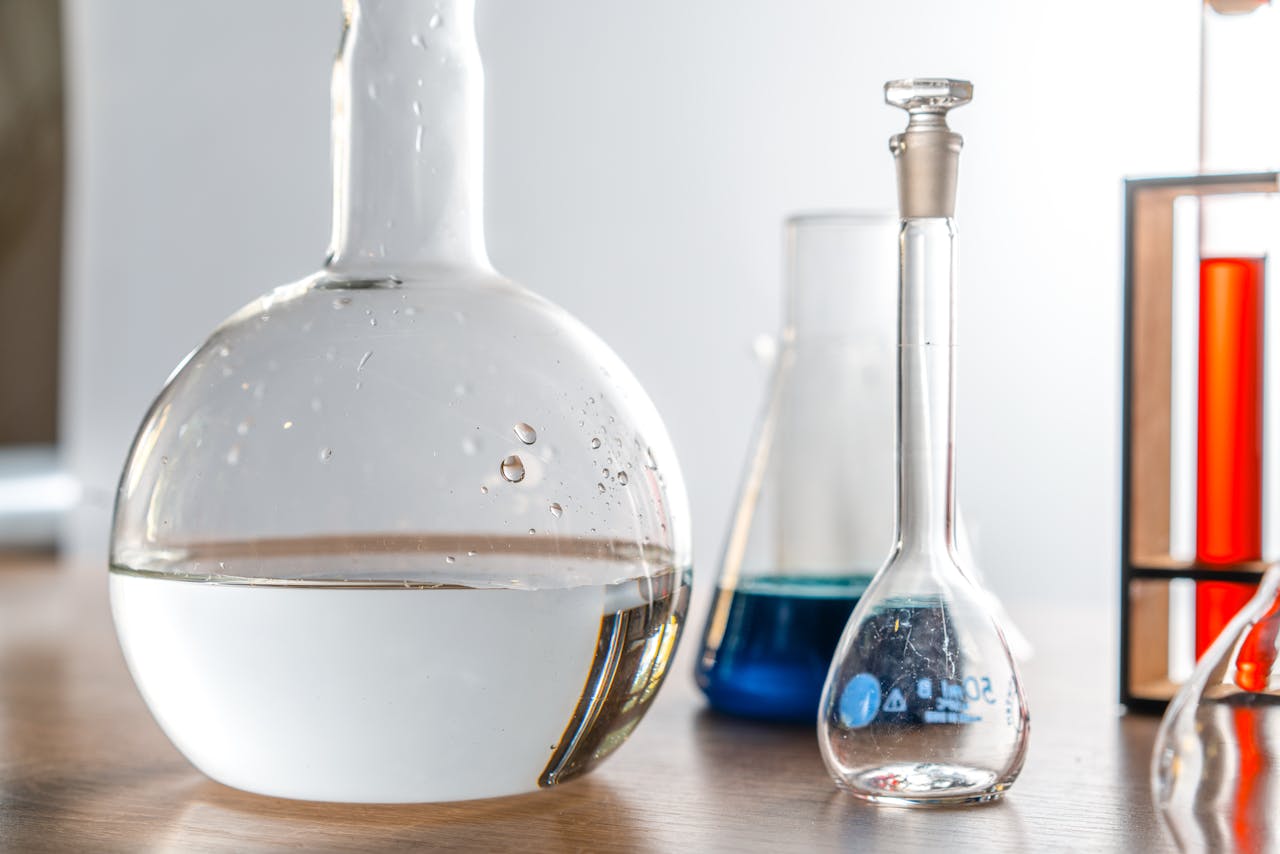 hero-services Close-up of laboratory glassware with various chemical solutions in a lab setting.